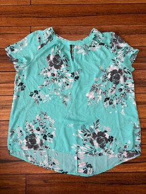 teal top with floral details.